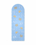 Blue pilates mat decorated with blue bows, white polka dots, and beige pastry print