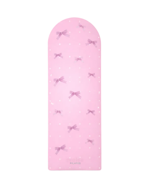 Pink pilates mat with white polka dots and pink bows